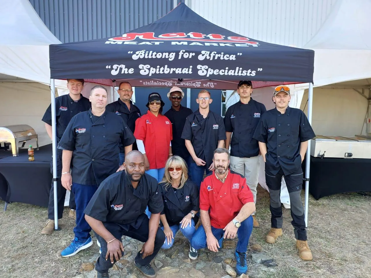 Matts Meat Market team under a branded function gazebo